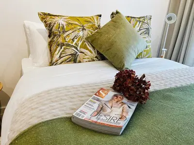 a magazine sitting on top of a bed at Platform 133 2 Tabak in Paarl