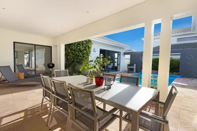 a dining room with a table and chairs at Villa on 15th Waters Edge, Cape Town in Cape Town