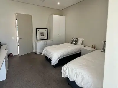 a bedroom with two beds with white sheets at Villa on 15th Waters Edge, Cape Town in Cape Town
