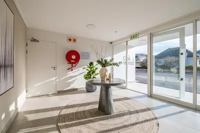 a hallway with a table and glass doors at Chic Coastal Hideaway in Hermanus