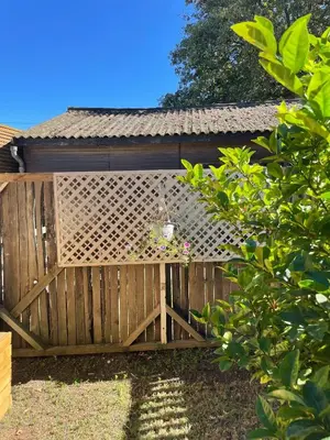 a wooden fence with a bird feeder on it at Honeymoon Stay at The James Family Farm in Grabouw