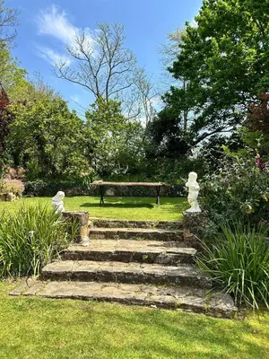 a set of stairs in a park with a bench at Honeymoon Stay at The James Family Farm in Grabouw