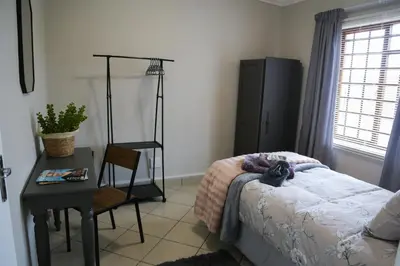 a bedroom with a bed and a table and a chair at Schutterend in Nieuwe Drift