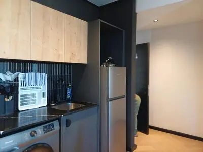 a kitchen with a refrigerator and a microwave at 1bedroom Luxe Nine Palms near Canal Walk in Cape Town