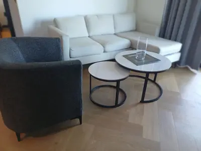 a living room with two tables and a couch at 1bedroom Luxe Nine Palms near Canal Walk in Cape Town