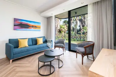 a living room with a couch and chairs and a table at Century City Natures Treat in Cape Town