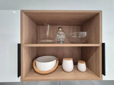 a wooden cabinet with bowls and vases in it at On Park - Century City Lux Studio Apartment in Cape Town