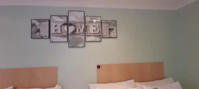 a room with two beds and a picture on the wall at Ojong's Self-Catering Ridgeworth - Bellville in Tyger Valley