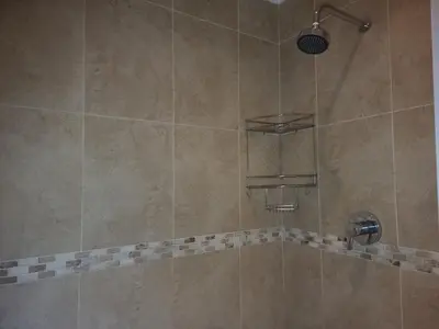 a shower with a shower head in a bathroom at Ojong's Self-Catering Ridgeworth - Bellville in Tyger Valley