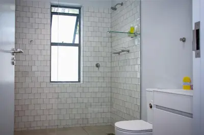 a bathroom with a toilet and a window at Upmarket Room in Stellenbosch