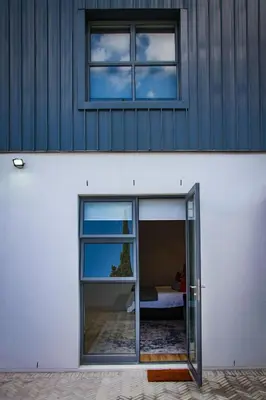 a building with a door and two windows at Upmarket Room in Stellenbosch