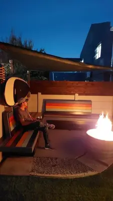 a young boy sitting on a bench with a laptop at Beach Pebble - 200m walk to beach kite surfer paradise, work friendly, pet friendly - must request in Bloubergstrand