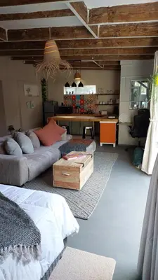 a living room with two couches and a table at Beach Pebble - 200m walk to beach kite surfer paradise, work friendly, pet friendly - must request in Bloubergstrand