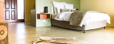 a bedroom with a bed with a dead animal on the floor at Kapensis Guesthouse II Venue & self-catering in Bettyʼs Bay