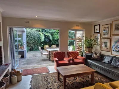 a living room with a couch and a table at Serendipity 2 Bedroom Family Home in Onrus in Hermanus