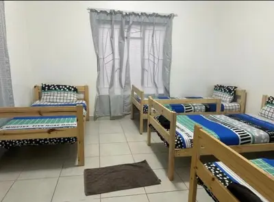 a group of four beds in a room at Sir Garnet Inn in Wolseley