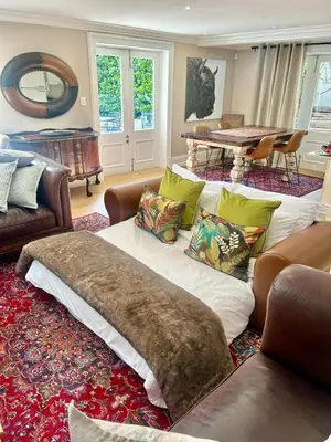 a living room with a couch and a table at French Manor 1 in Stellenbosch