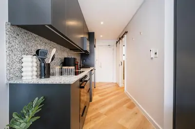 a kitchen with a counter top and a hallway at Paarl 137 - Superior Studio Apartment with AC and Parking in Paarl