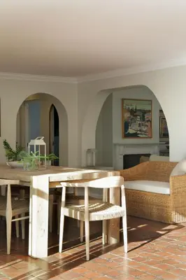 a living room with a wooden table and chairs at Seabreeze Retreat in Hermanus