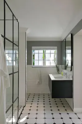 a white bathroom with a sink and a mirror at Seabreeze Retreat in Hermanus