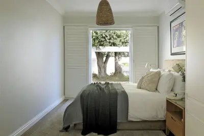 a bedroom with a bed and a window at Seabreeze Retreat in Hermanus