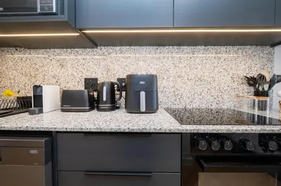a kitchen counter with a coffeemaker on it at Paarl Studio 138 - Ultra Modern Apartment with AC and onsite Parking in Paarl