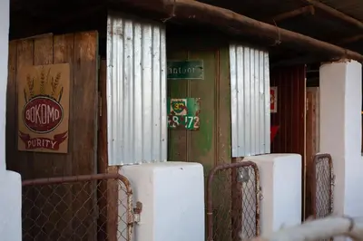 an old building with a sign on the side of it at Blouporselein guestfarm cabin in Hermon