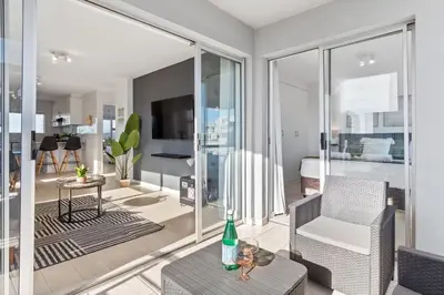 a living room with a couch and a chair at Ocean View B503 in Cape Town