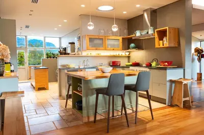 a kitchen with a island in the middle of a room at Stellenbosch Farm Stay with Mountain Views & Pool in Stellenbosch