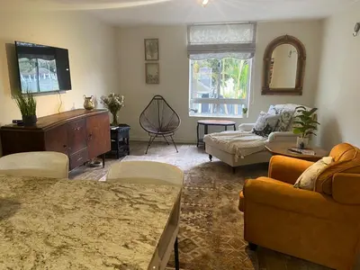 a living room with a couch and a tv at Amatoni 44 in Stellenbosch