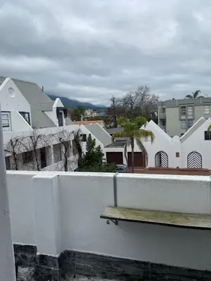 a wooden bench sitting on a white fence at Amatoni 44 in Stellenbosch