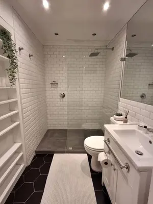 a white bathroom with a toilet and a sink at The Harfield Hideaway in Cape Town