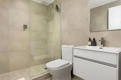 a bathroom with a toilet and a sink and a shower at Beautiful Beach Break! in Cape Town