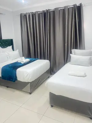 a bedroom with two beds and a window at The Perfect Place in Parow