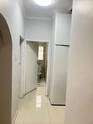 an empty hallway with a refrigerator in a room at The Perfect Place in Parow
