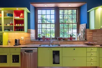 a kitchen with green cabinets and a sink at The Manor at Mont Angelis Estate in Stellenbosch