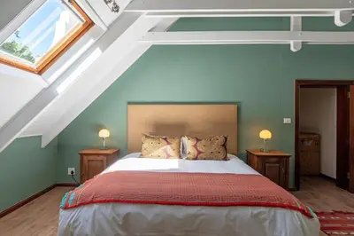 a bedroom with a large bed in a attic at The Manor at Mont Angelis Estate in Stellenbosch