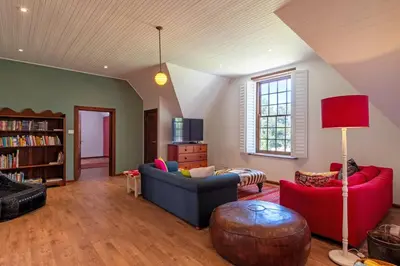 a living room with two couches and a table at The Manor at Mont Angelis Estate in Stellenbosch