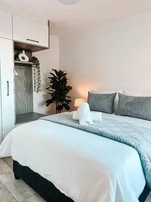 a bedroom with a large white bed in a room at Ebb & Flow in Hermanus