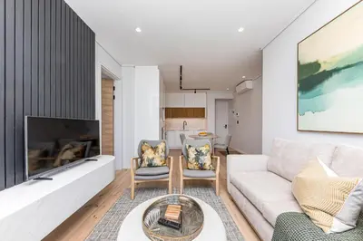 a living room with a couch and a fireplace at Aan de Meul Luxury Apartments in Stellenbosch