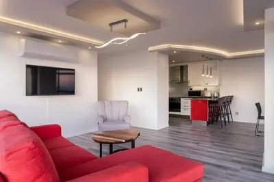 a living room with a red couch and a kitchen at 903 Atlantica in Strand
