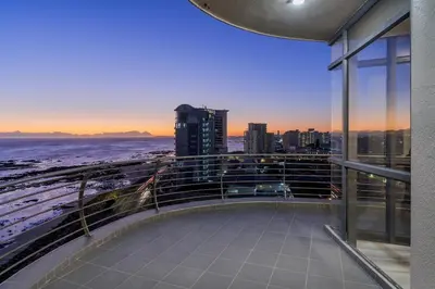 a balcony of a building with a view of the ocean at 903 Atlantica in Strand
