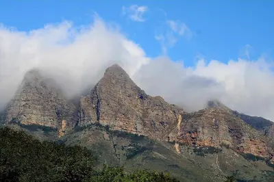a mountain with some clouds on top of it at La Vita Romantic Getaway Cabin in Wellington