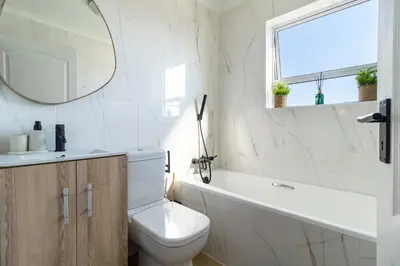 a bathroom with a toilet and a sink and a mirror at 2 Bedroom, Mountain View Penthouse, Century City in Cape Town