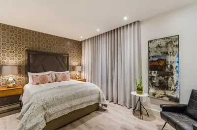 a bedroom with a large bed and a couch at 107 Dorpstraat Boutique Hotel in Stellenbosch