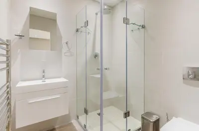 a bathroom with a glass shower and a sink at 107 Dorpstraat Boutique Hotel in Stellenbosch