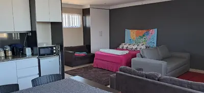 a small living room with a couch and a table at Murray Guest Suite in Goodwood