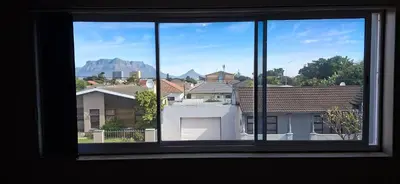 a window view of a city with a mountain in the background at Murray Guest Suite in Goodwood
