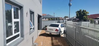 a white car parked next to a house at Murray Guest Suite in Goodwood