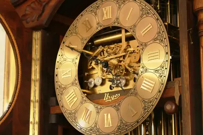 a gold clock with a mechanism on a wooden wall at The Welgemoed Guest House in Bellville